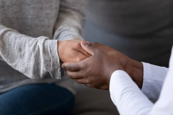Close up of multiethnic couple hold hands showing love — Stock Photo, Image