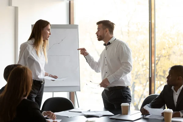 Angry male and female colleagues argue at corporate team meeting — Stock Photo, Image