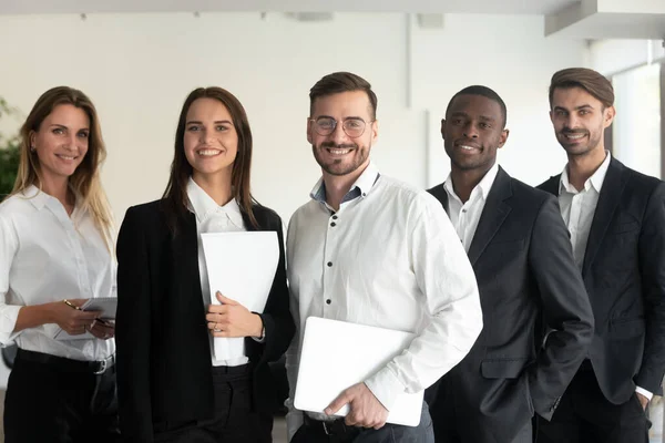 Smiling multiracial professional business team looking at camera, portrait