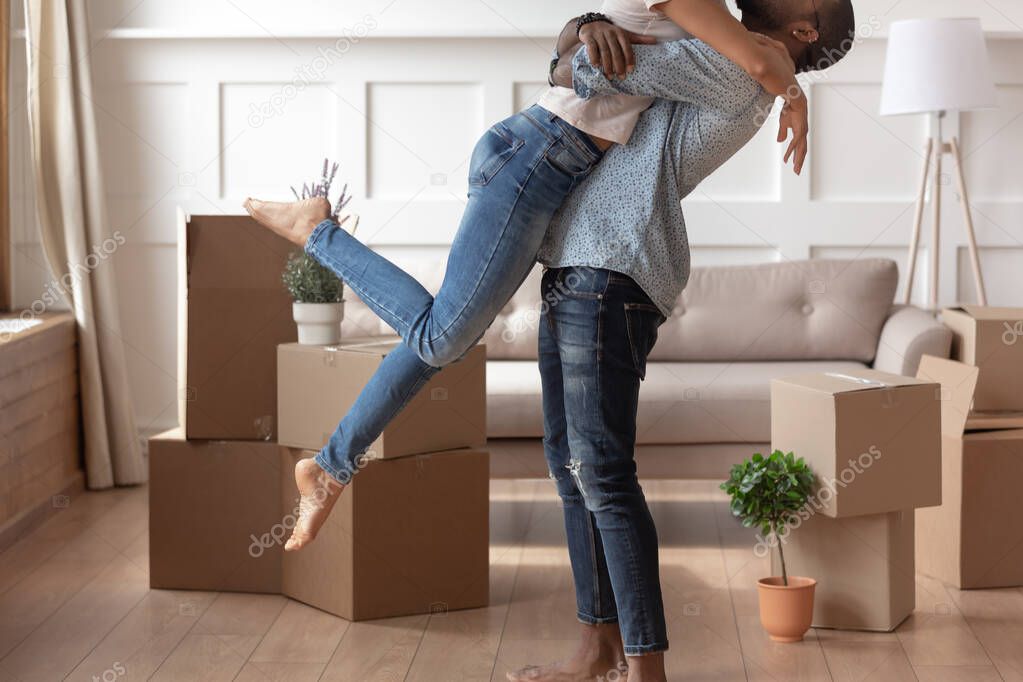 Happy husband lift kiss wife excited to move together