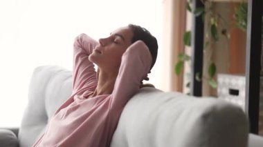 Relaxed woman leaned on couch closed eyes enjoy day nap