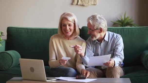 Feliz pareja de ancianos gestionar el presupuesto familiar utilizando la banca electrónica en línea — Vídeo de stock