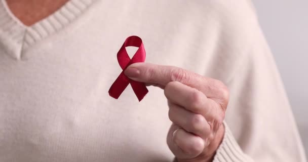 Close up middle aged mature woman showing fight cancer symbol. — Stock Video