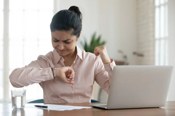 Unhappy millennial woman checking time to workday finish. — Stock Photo, Image