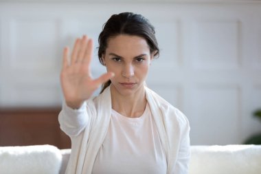 Portrait of confident woman show stop hand gesture clipart