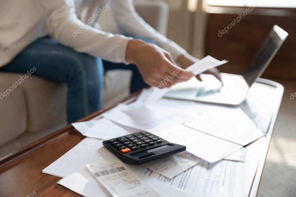 Close up of woman manage household finances at home