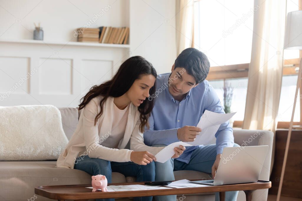 Caucasian couple pay bills online mange finances