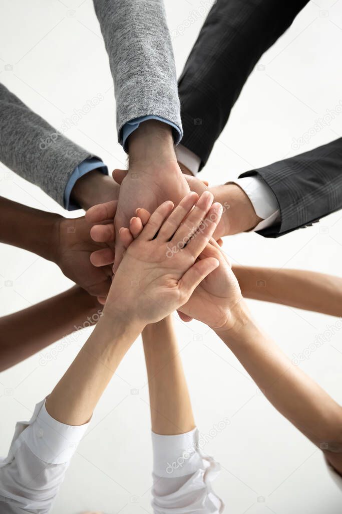 Close up vertical photo diverse business people stacking hands