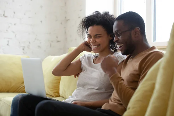 African couple read on pc notification from bank feels happy