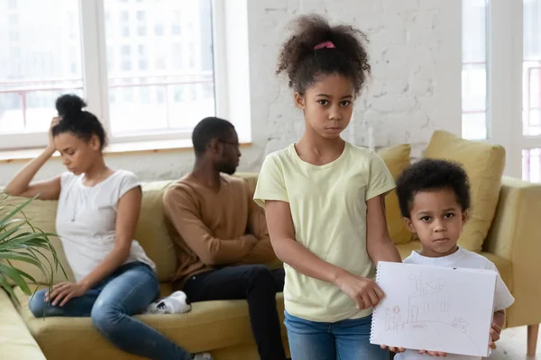 Unhappy little African children holding drawing suffers from parents divorce — Stock Photo, Image