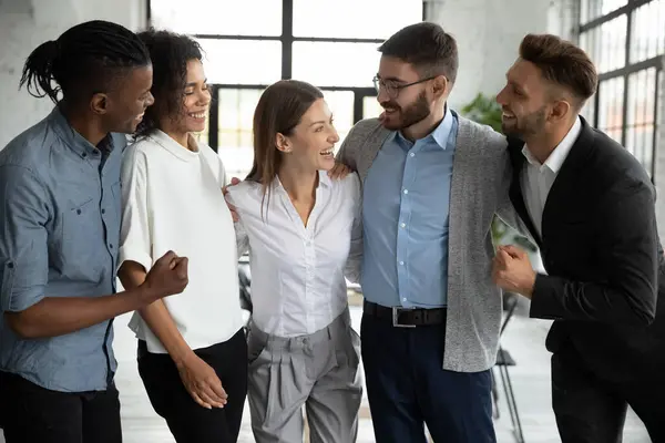 Happy diverse employees team celebrating success, hugging with team leader — Stock Photo, Image