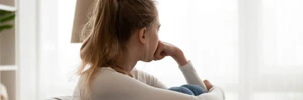 Girl sitting on couch feels frustrated horizontal photo banner — Stock Photo, Image