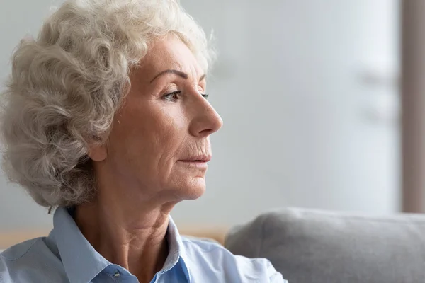 Pensive serious old woman face profile closeup view — Stock Photo, Image