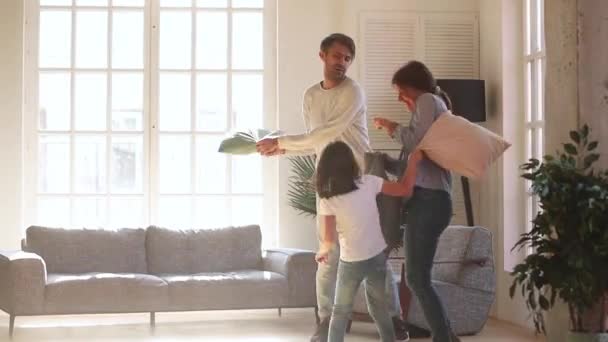 Cheerful active family playing fight with pillows — Stock Video