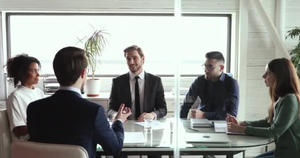 Happy business partners negotiate handshake at board group meeting table — Stock video