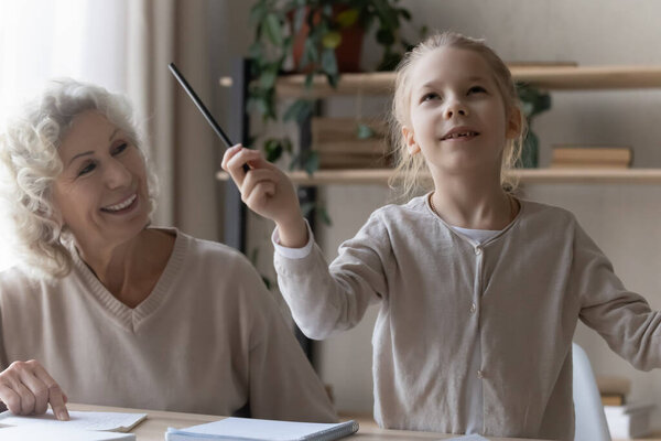 Funny little girl have fun studying at home