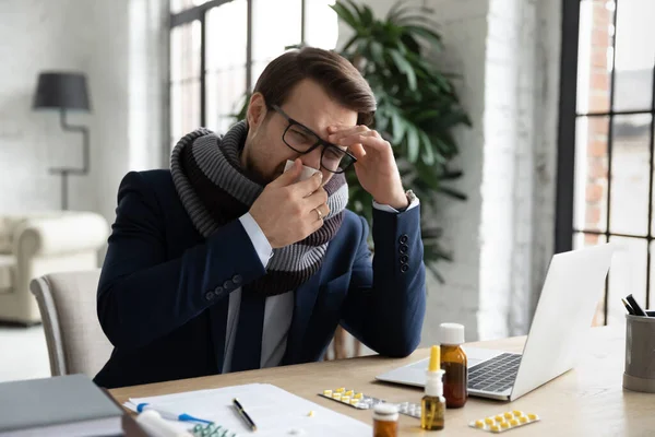 Sick male employee suffer from fever at workplace — Stock Photo, Image
