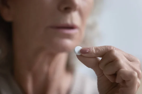 Close up of mature woman think of having medicines — Stock Photo, Image