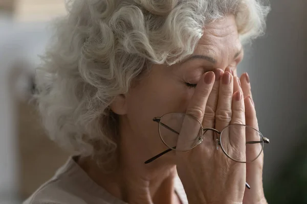 Exhausted senior female suffer from blurry vision — Stock Photo, Image