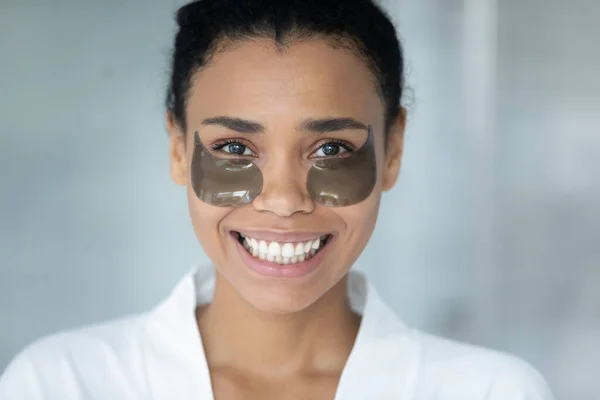 Head shot portrait African American woman with under eye mask — Stock Photo, Image