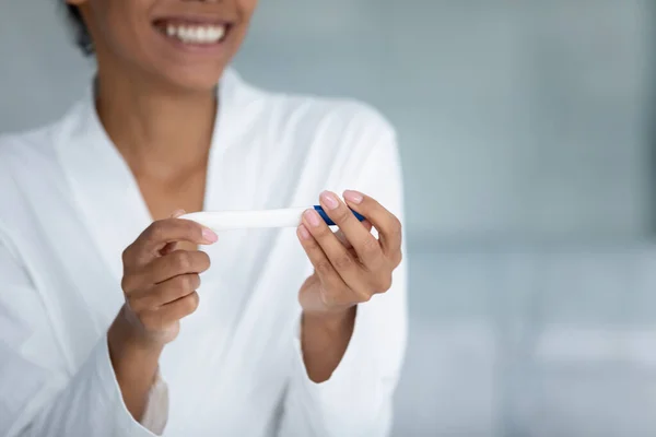 Close up sorridente donna afroamericana che tiene test di gravidanza — Foto Stock