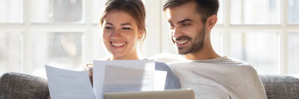 Couple read documents check bank account balance feels satisfied