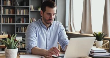 Concentrated male professional analyzing market research information.