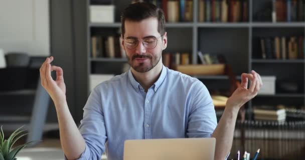 Tranquillo calmo giovane lavoratore maschile che fa esercizi di respirazione yoga in ufficio . — Video Stock