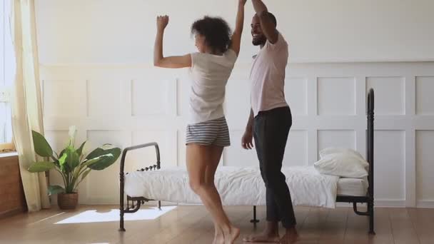 Happy romantic black husband and wife enjoy dance in bedroom — Stockvideo