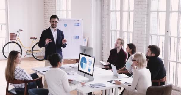 Happy mixed race employees listening to team leader. — Stock video