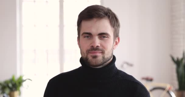 Head shot smiling young handsome bearded businessman standing in office. — Stock video