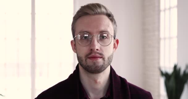 Happy handsome employee in eyeglasses looking at camera. — Stok video