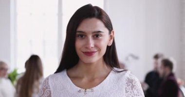 Happy young woman satisfied with corporate job career at office.