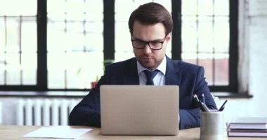 Focused male ceo executive manager managing tasks on paper checklist.