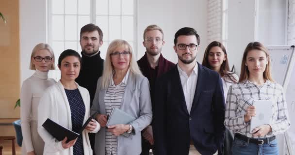 Smiling team of diverse business people looking at camera. — Stock video