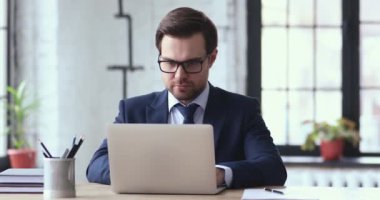 Overjoyed young businessman excited by unbelievable good news.
