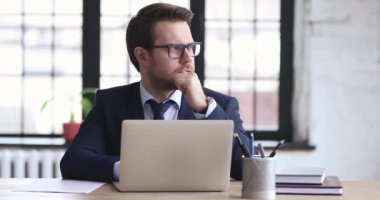 Pensive businessman in suit solving problems, write notes.