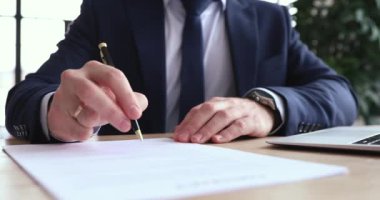 Focused executive ceo signing report after checking information.