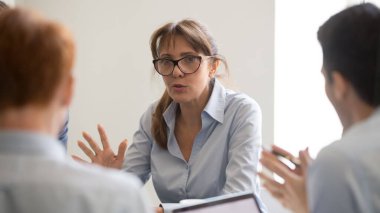 Confident businesswoman leader speaking, discussing startup at briefing