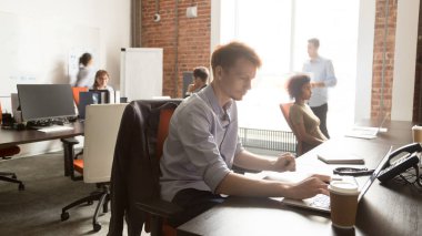 Diverse employees using, working on computers, everyday office routine