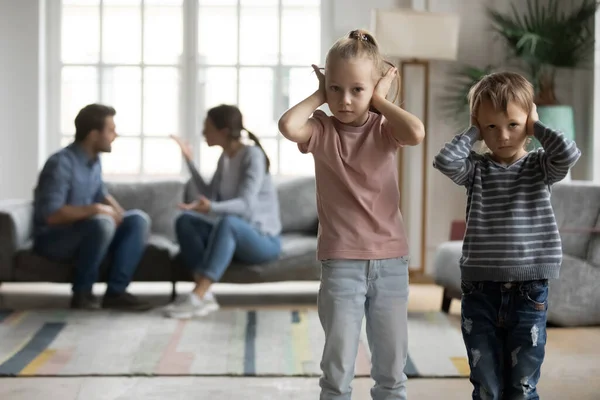 Unhappy little kids covering ears, suffering from parents argument — Stock Fotó