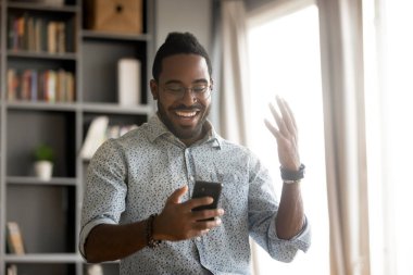 African man holding smartphone read message feels excited
