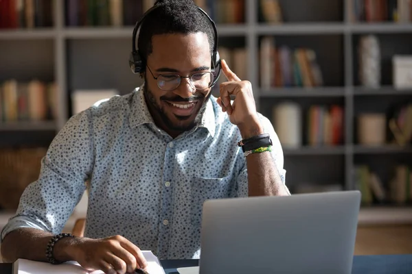 African man wear headset watching webinar video course — Stock Photo, Image