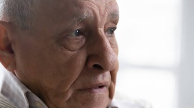 Close up thoughtful upset elderly man feeling lonely and depressed