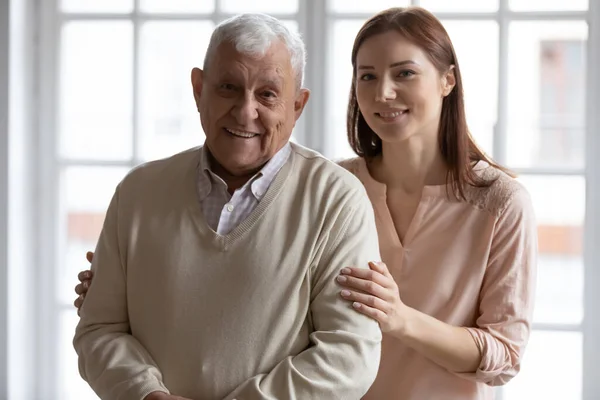 Head shot portrait smiling older man with grownup daughter — Stock Fotó