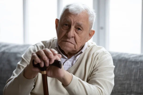 Head shot portrait depressed lonely elderly man with cane — Stockfoto