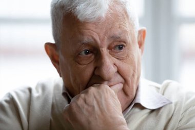 Head shot thoughtful upset elderly man thinking about problems