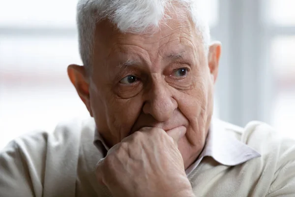 Head shot thoughtful upset elderly man thinking about problems — Zdjęcie stockowe