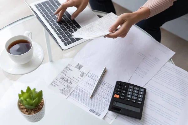 Top view close up woman calculating bills, using laptop — Stok Foto