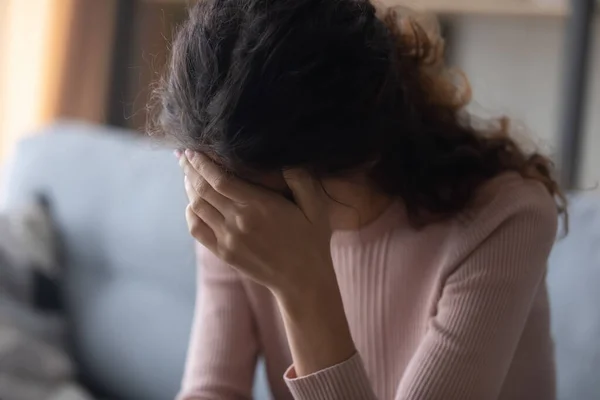 Close up frustrated depressed woman touching forehead, sitting alone — Stock Photo, Image